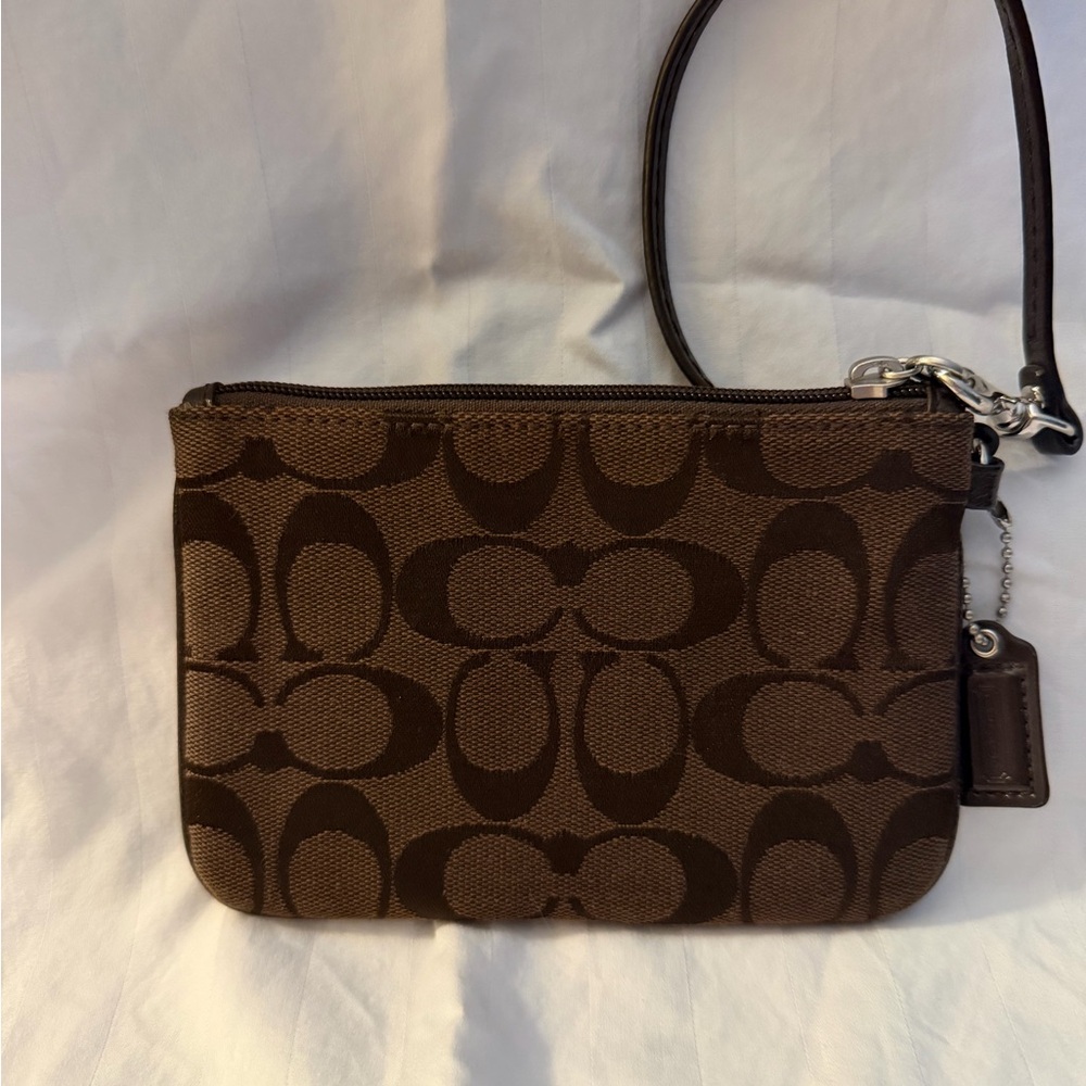 Coach Signature C canvas wristlet.